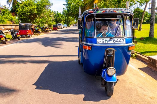 Bentota Beach Southern Province Sri Lanka 16. March 2018 Driving a blue Rickshaw Tuk Tuk cab vehicle in Bentota Beach Galle District Southern Province Sri Lanka.