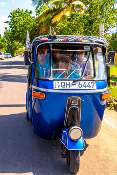 Bentota Beach Southern Province Sri Lanka 16. March 2018 Driving a blue Rickshaw Tuk Tuk cab vehicle in Bentota Beach Galle District Southern Province Sri Lanka.