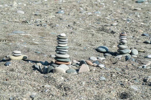 large pebbles stacked on the sand of the beach. photo