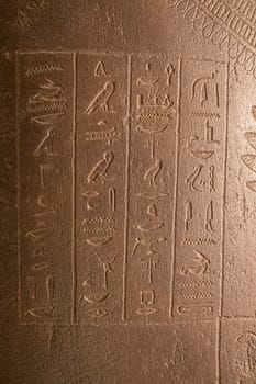 Egyptian hieroglyphs on a stone in a tomb close-up. photo