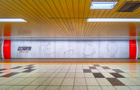 tokyo, japan - apr 28 2024: Poster lining the corridors of Shibuya subway featuring bullet holes spelling out the Japanese word 'mokkori' or 'erection' in promotion of the Netflix movie "City Hunter"