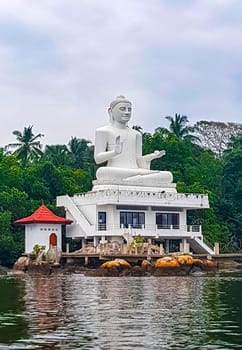 Large white Buddha statue in Bentota Udakotuwa Temple at Bentota Ganga in Bentota Beach Galle District Southern Province Sri Lanka.