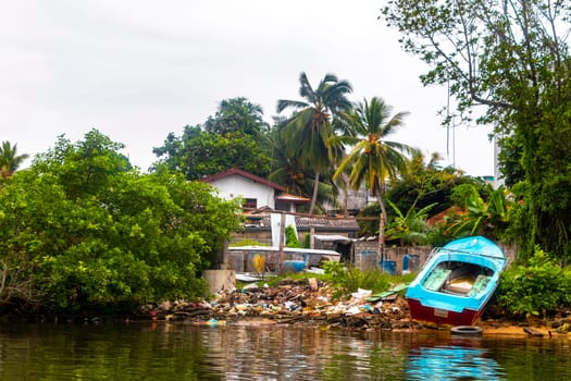 Terrible pile of garbage boat safari trip jetty house boats through mangrove jungle forest in Bentota Ganga River Lake in Bentota Beach Galle District Southern Province Sri Lanka.