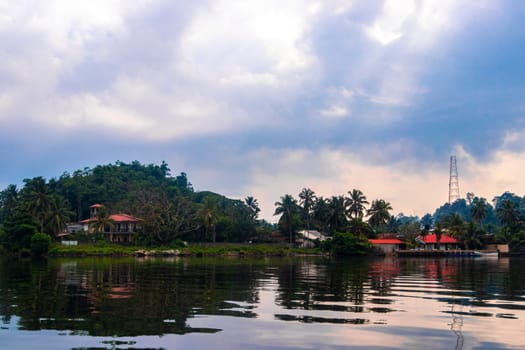 Boat safari trip jetty house boats through mangrove jungle forest in Bentota Ganga River Lake in Bentota Beach Galle District Southern Province Sri Lanka.