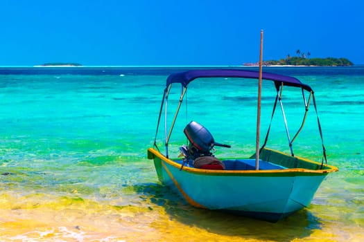 Motor engine of a speedboat in the blue turquoise water on Rasdhoo island in Rasdhoo Atoll Maldives.