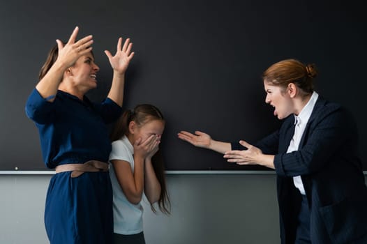 A female teacher and a student's mother yell at each other at the blackboard. The schoolgirl is crying