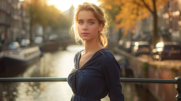 A woman in a blue dress stands on a bridge overlooking a canal. The scene is serene and peaceful, with the woman's gaze directed towards the water