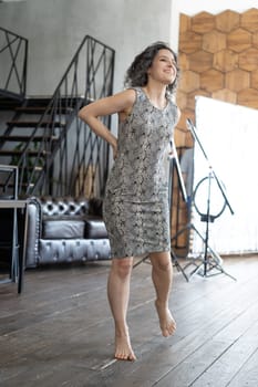 young beautiful woman posing in a short dress in the studio