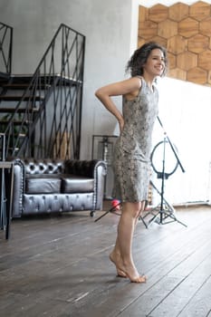 young beautiful woman posing in a short dress in the studio