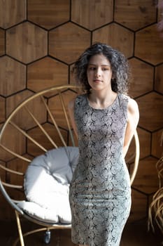 young beautiful woman posing in a short dress in the studio