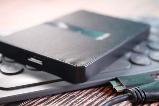 stack of external hard drives on table .