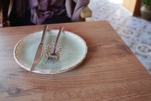 fork, knife and a circle shape plate on table .
