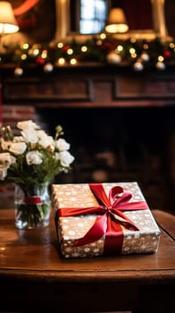 Christmas gift box near cosy fireplace in the English country cottage, winter holidays, boxing day celebration and holiday shopping inspiration
