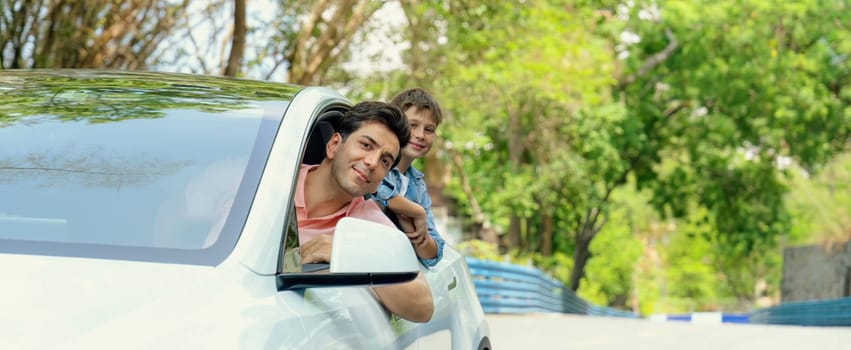 Dad and son on the road trip by the green nature countryside, family vholiday vacation concept. Young little boy enjoying family car adventure vacation with his father. Perpetual