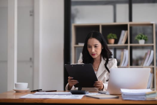 Young businesswoman has problems with her work in the office Feeling stressed and unhappy, showing a serious expression.