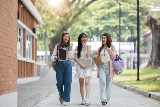 Group of Young Asian student walking and talking at university before class room. education, back to school concept.