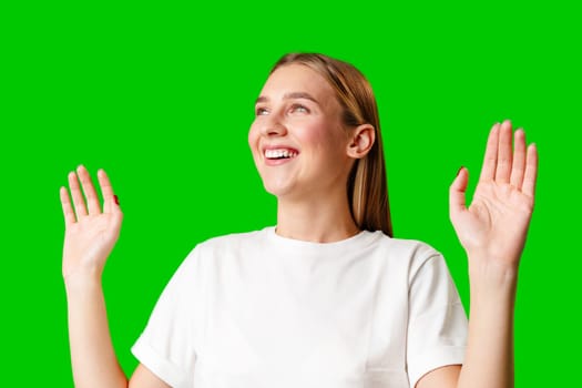 Young Woman in White T-shirt Making a Surprised Face on green background