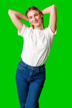 Young Woman in White Shirt Posing for Picture against green background in studio