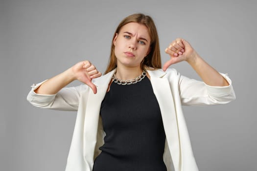 Woman Gesturing With Her Hands Thumbs Down in Studio