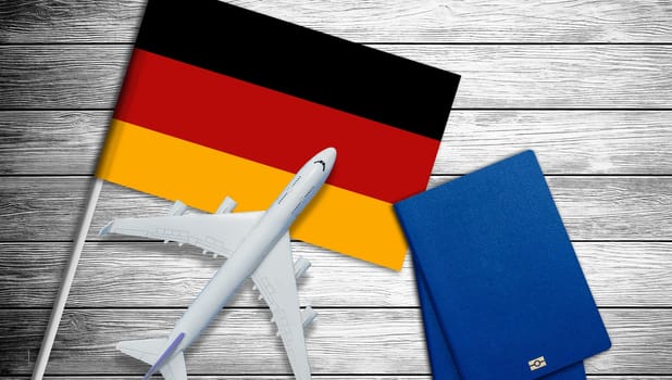 Flag of Germany with passport and toy airplane. Flight travel concept. High quality photo