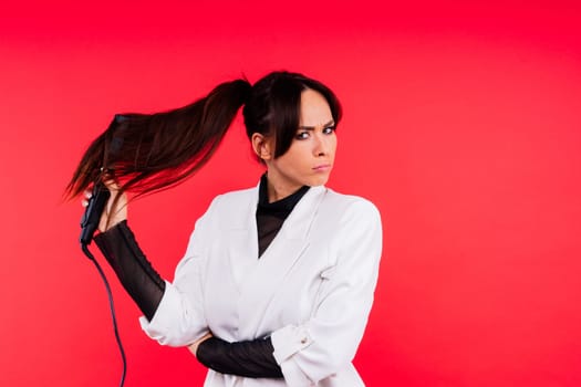 Brunette female holds hairdresser equipment. Beauty and style industry profession. Hairdresser.