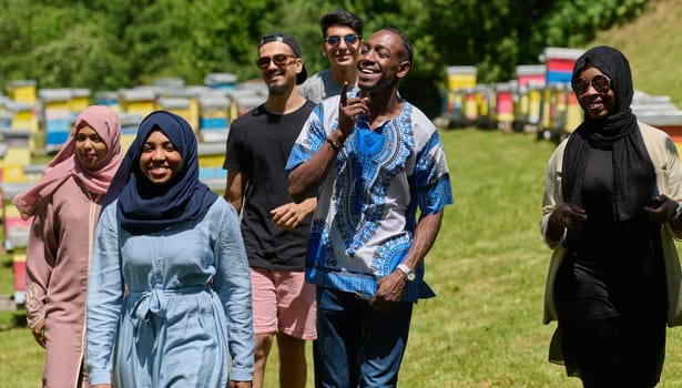 A diverse group of young friends and entrepreneurs explore small honey production businesses in the natural setting of the countryside