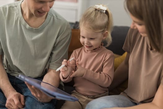 Deaf child girl with cochlear implant studying to hear sounds - recovery after cochlear Implant surgery and rehabilitation