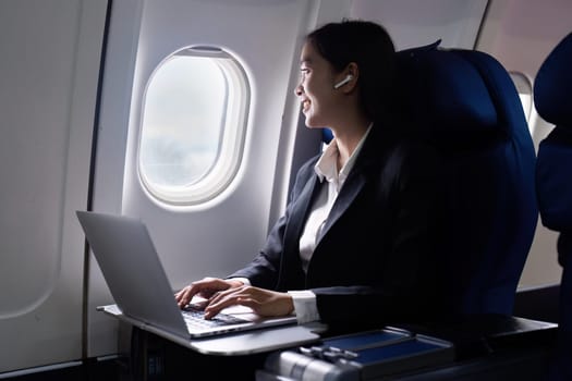 businesswoman flying and working in an airplane in first class, Man sitting inside an airplane using laptop.
