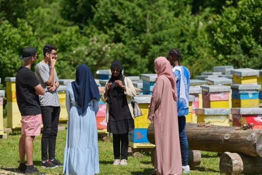 A diverse group of young friends and entrepreneurs explore small honey production businesses in the natural setting of the countryside