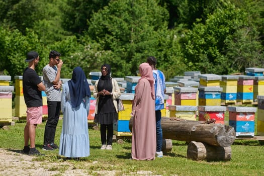 A diverse group of young friends and entrepreneurs explore small honey production businesses in the natural setting of the countryside