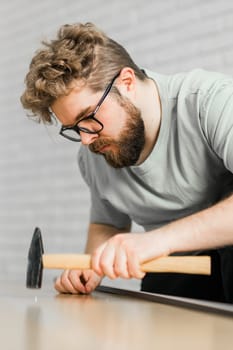 Portrait of man assembling furniture. Do it yourself furniture assembly.