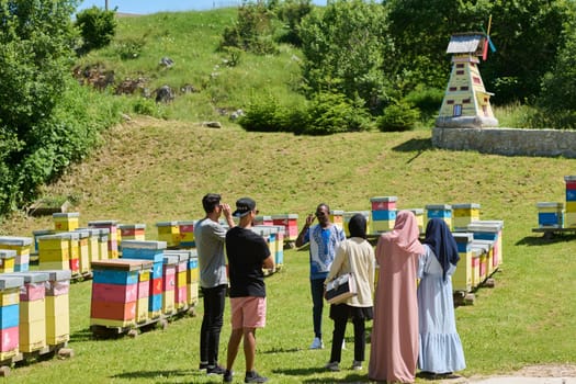A diverse group of young friends and entrepreneurs explore small honey production businesses in the natural setting of the countryside
