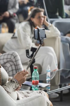 Man taking selfie picture on event indoors. Focus on phone. Blogger and vlog