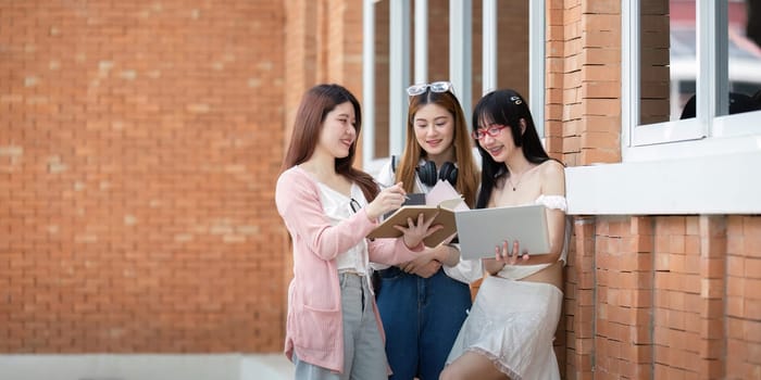 Asian young campus student enjoy learn study and reading books together. Friendship and Education concept. Campus school and university. Happiness and funny of learning in college.