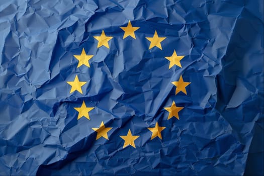 Blue paper with crumpled texture and gold stars resembling the flag of the European Union