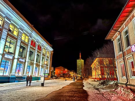 Arkhangelsk, Russia - February 28, 2024: street at night in winter. Snowy, cobblestone street adorned with lights