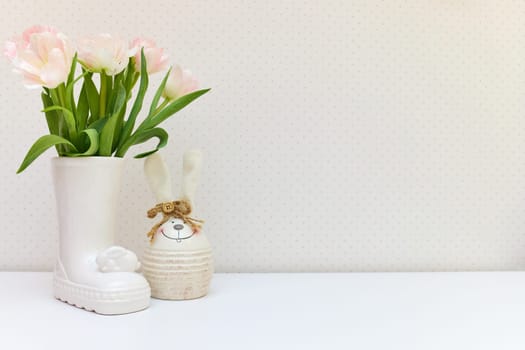 bouquet of tulips and Easter bunny on white table. copy space