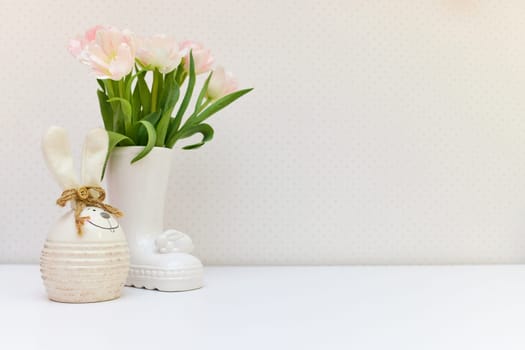 bouquet of tulips and Easter bunny on white table. copy space