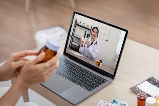 Elderly woman sit at home having online consultation with doctor on computer laptop, sick senior talk on video call consulting with nurse using laptop, healthcare concept.