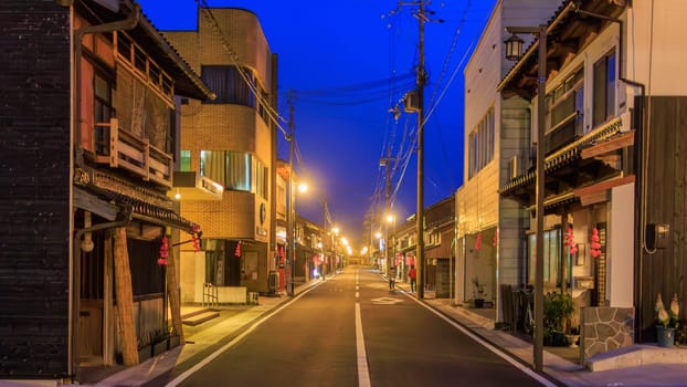 Lights on empty main street by closed shops and buildings in Takeda Town . High quality photo