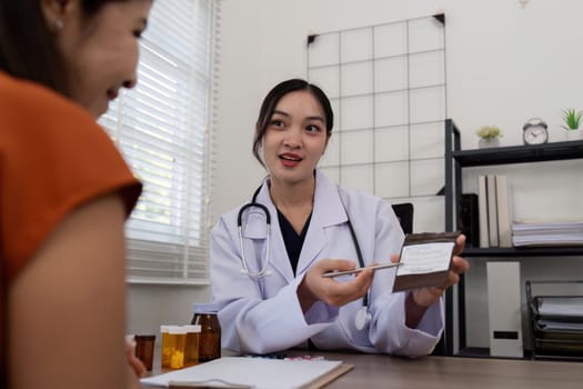Doctor woman are recommend medicine to elderly woman patient after being examine by the patient doctor, the concept of treatment and symptomatic medication dispensing by the pharmacist.