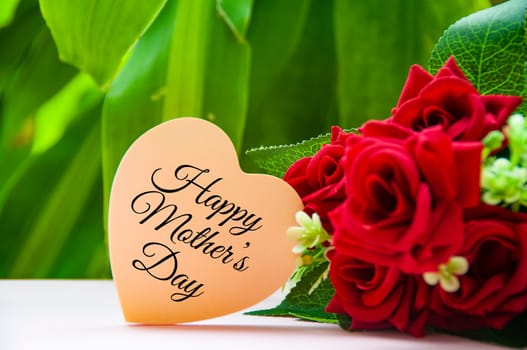 Happy mother's day text on light pink paper heart shape. Happy Mother's Day Concept.