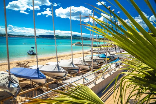 Sainte Maxime sand turquoise beach and sailboats view, Cote D Azur in France