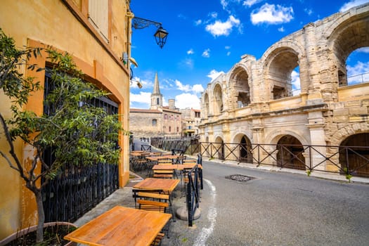 Arles Amphitheatre and colorful street architecture view, South of France