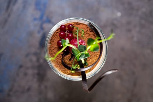 top view tiramisu dessert with berries in a glass on the table.