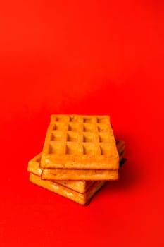 fresh waffle with filling on a red background.