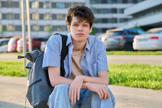 Portrait of confident smiling college student guy, young male with backpack looking at camera, urban outdoor. Education, lifestyle, 19,20 years age youth concept