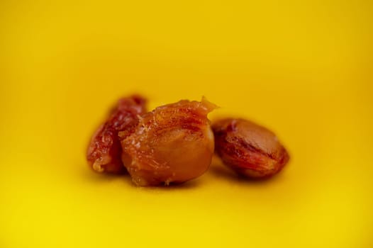 cherry seeds in close-up on a yellow background.