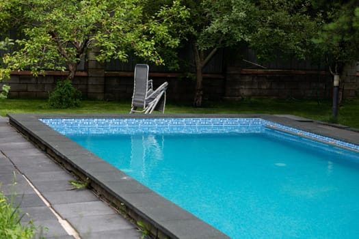 summer swimming pool in the courtyard with a garden.