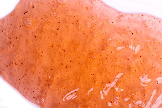 Orange slime with glitter, slime toy close-up.